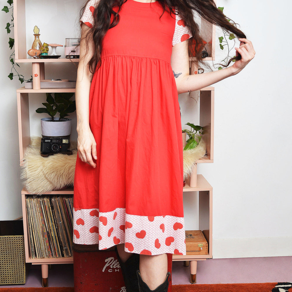 Front view of 1970s homespun junior dress with heart print sleeves and “love” trim, vintage Raggedy Ann style Lovers Vintage and Palomino Traders Collab